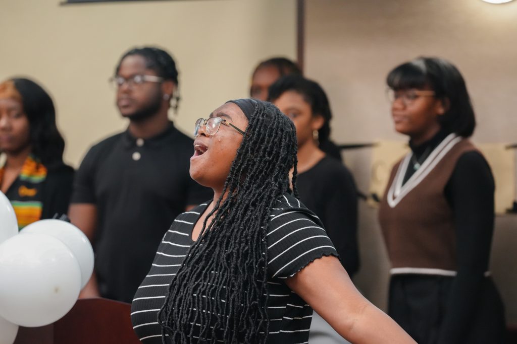 A member of the Legion of Black Collegians Gospel Choir sings a solo from “Let Praises Rise” by Myron Butler.