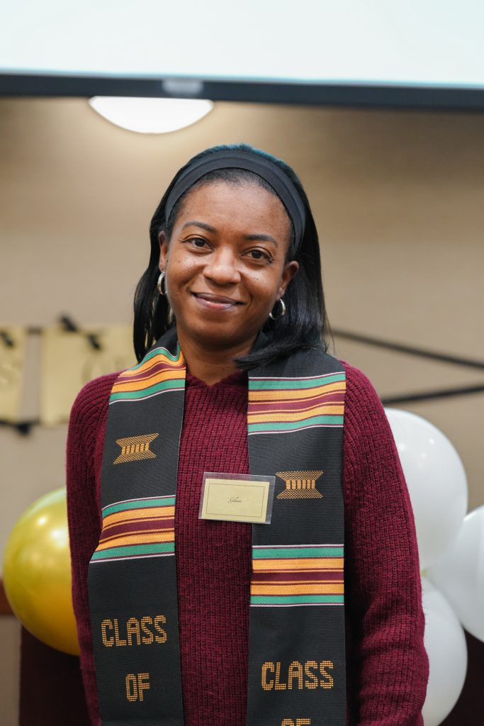 One mother and graduating CASE scholar gives a smile for the camera after receiving her Kente Stole during Salute to Excellence.