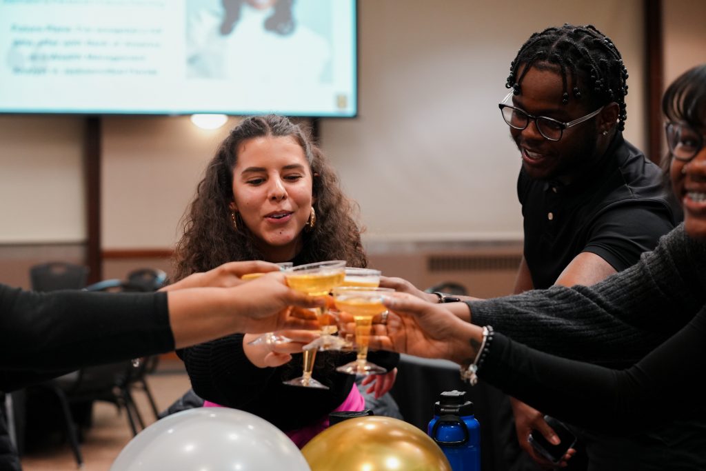 Attendees of the Salute to Excellence ceremony make a toast to the graduating scholars with sparking apple juice.