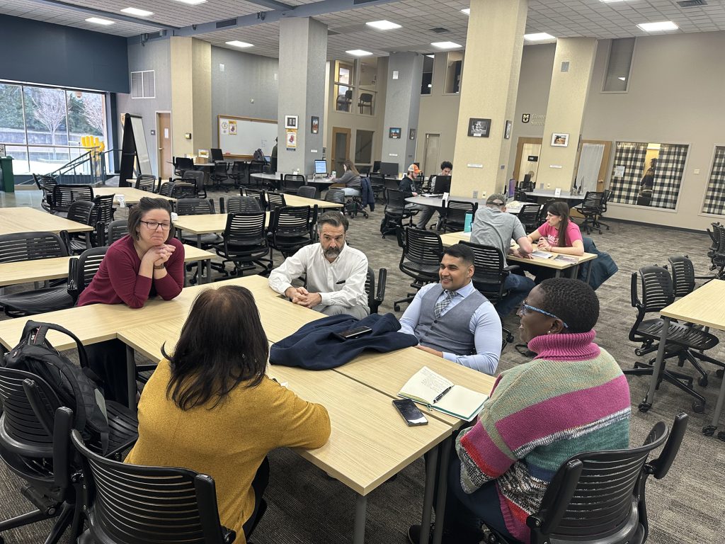 UWC delegation, Bailey Boyd PhD Candidate in the English Department and Dr. Aaron Harms Director of the MU Writing Center, chat about writing support resources and student success in the Student Success Center on Feb. 21, 2023. (Clockwise from left: Boyd, Dr. Aaron Harms, Shaikjee, Booi and Pather.)
