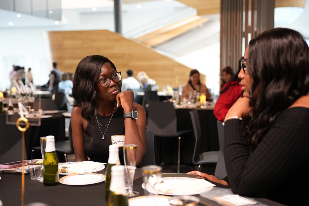 Two graduating scholars have an intimate conversation before the Salute to Excellence ceremony begins on April 27, 2023. (CASE photos/Braiden Wade)