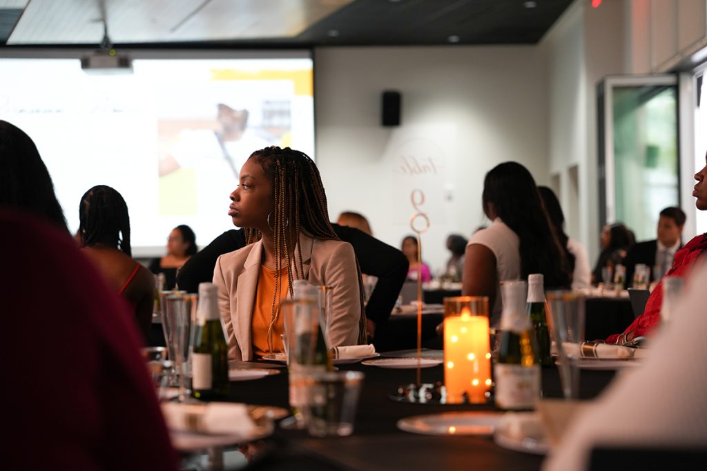 One graduating scholar turns her attention to the stage as lights are dimmed to set the candle lit tone of the ceremony on April 27, 2023. (CASE photos/Braiden Wade)