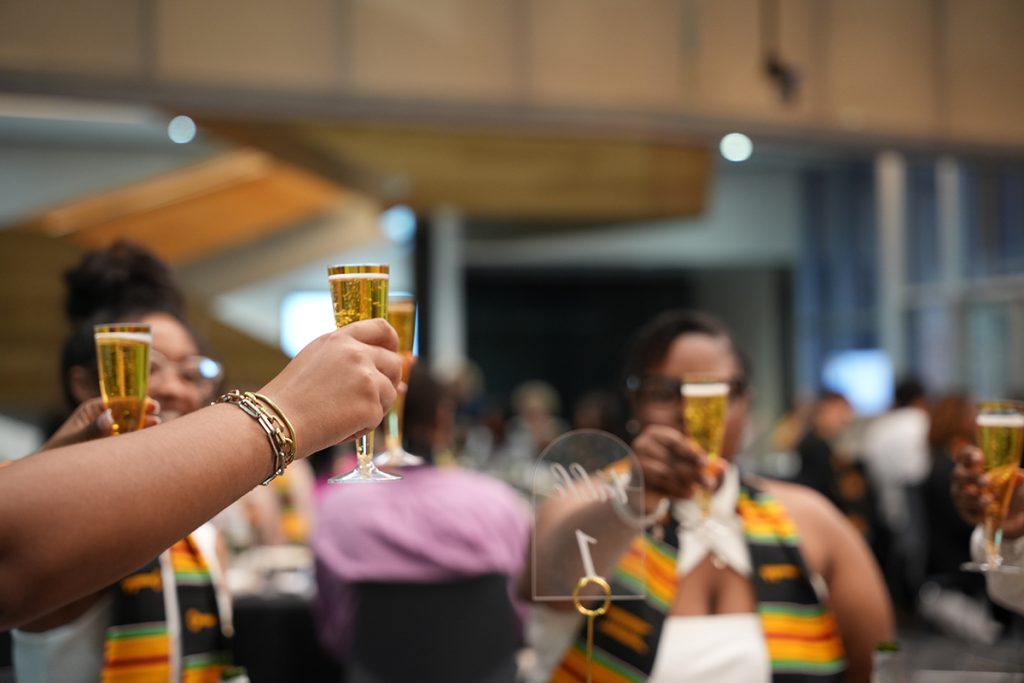 Several graduating scholars raise their glasses for a toast with sparking cider at the end of the ceremony on April 27, 2023. (CASE photos/Braiden Wade)